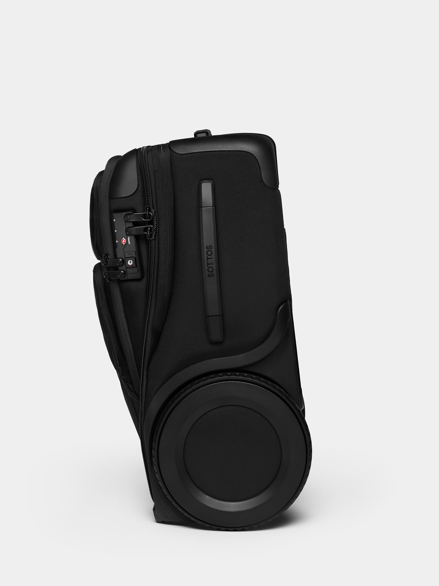 A side view of a black Roll Model Carry On featuring a big black wheel.