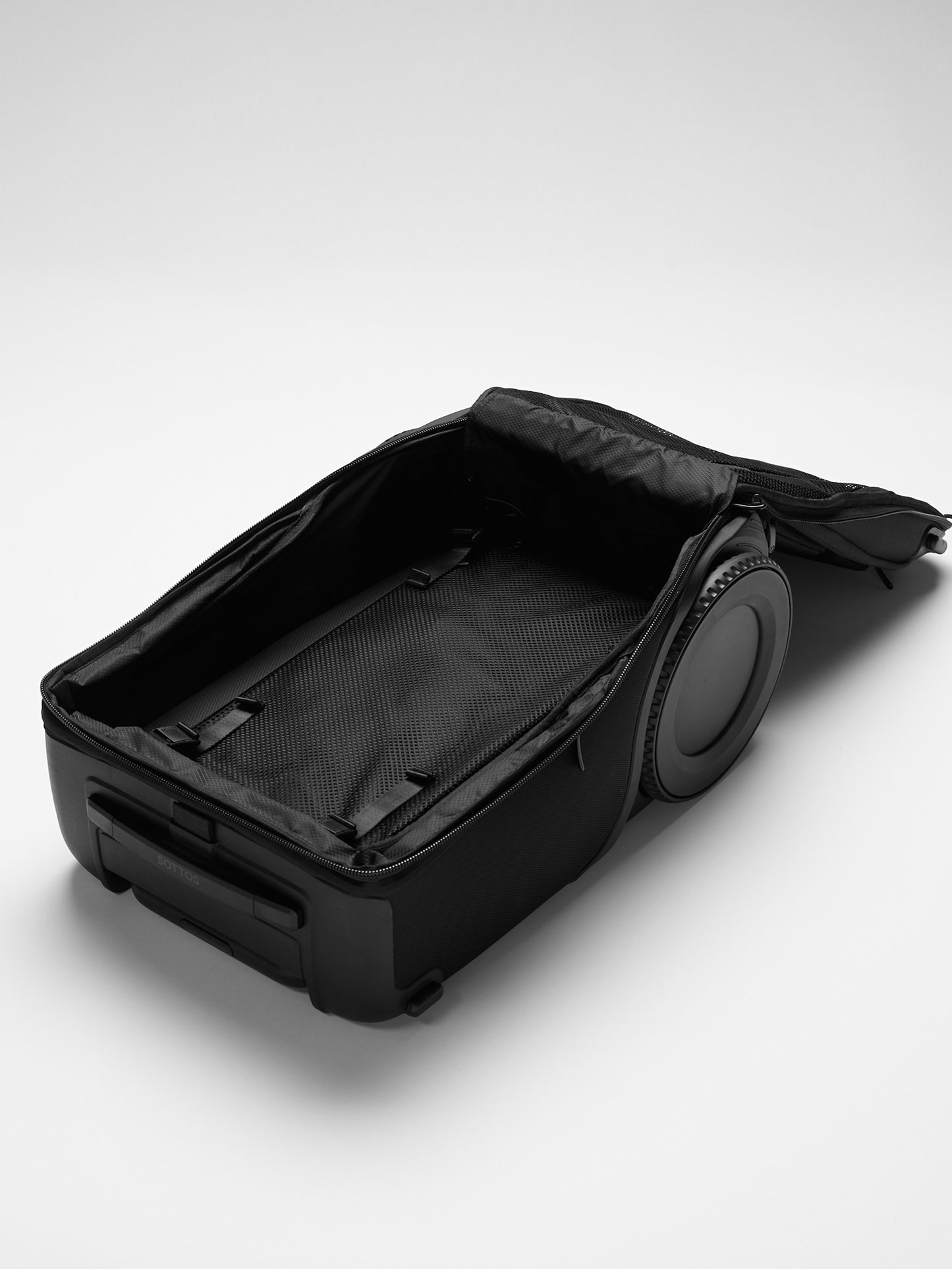 An unzipped and open Roll Model™ showing the detachable flat divider inside the bag.