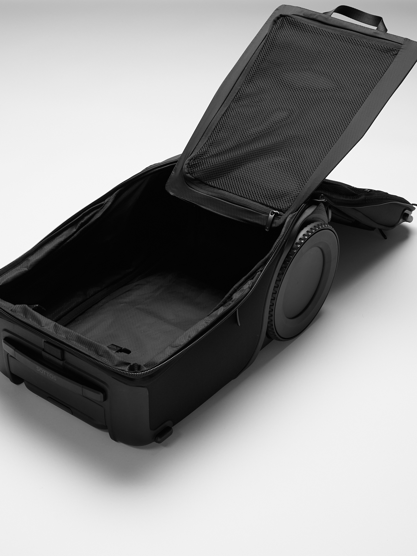 An unzipped and open Roll Model™ showing the depths of the bag and detachable flat divider.